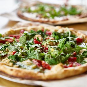 authentic gourmet pizza with fresh arugula, pesto and chicken Spicy Chicken Pizza